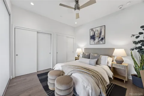 a bedroom with a bed and a potted plant