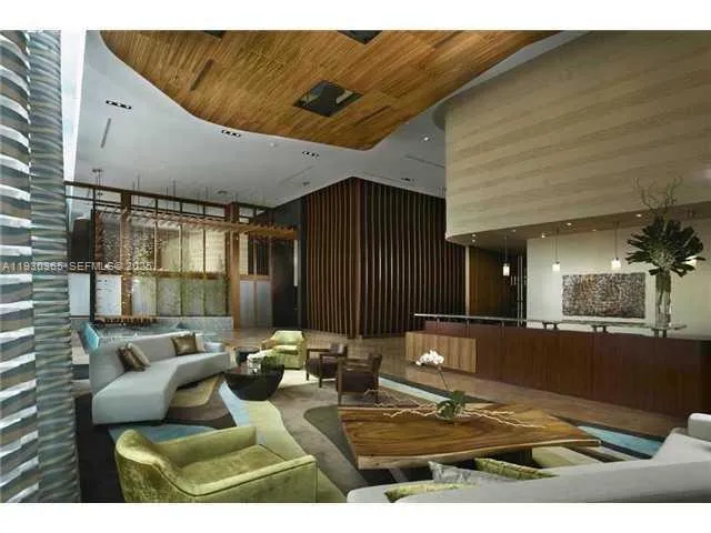 a view of a living room and kitchen