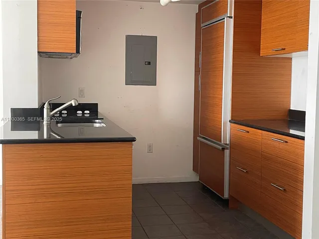 a kitchen with a refrigerator and cabinets