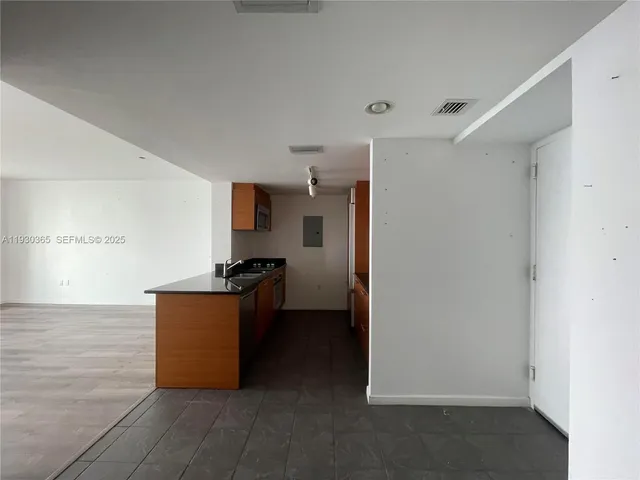 a kitchen with granite countertop a refrigerator and a stove