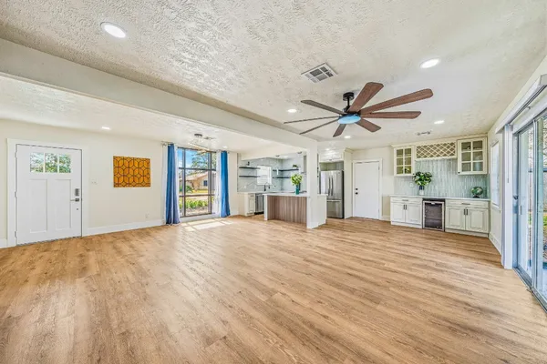 a view of a livingroom with a ceiling fan and window