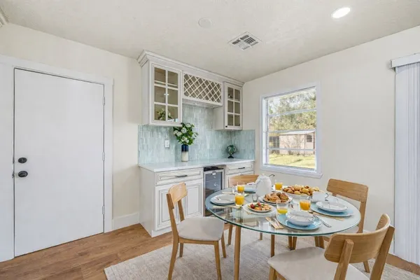 a view of a dining room with furniture and window
