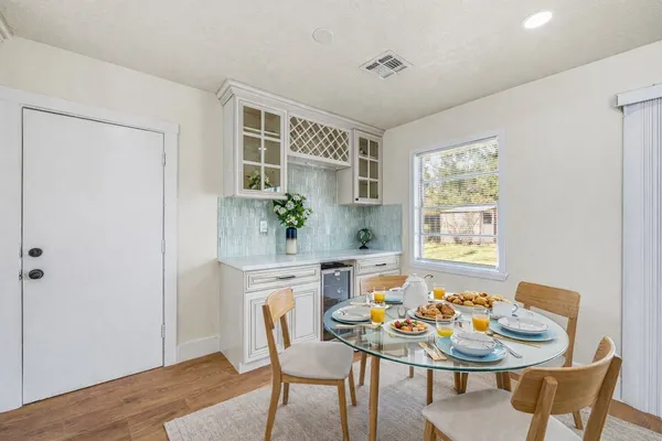 a dining room with furniture a rug and wooden floor