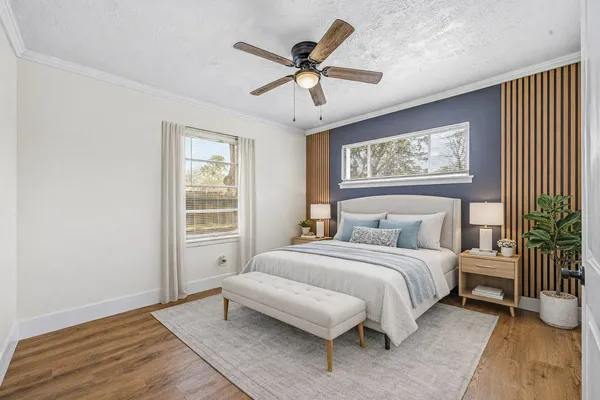 a bedroom with a bed and a window