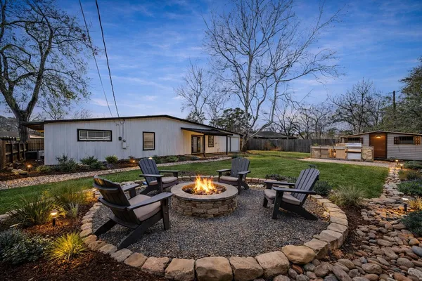 a backyard of a house with outdoor seating