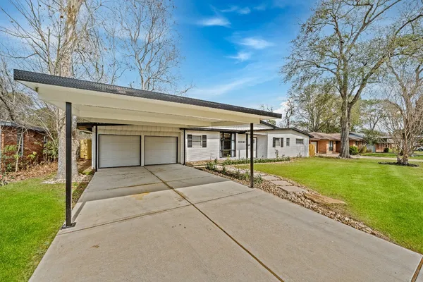 a view of house with outdoor space and garden