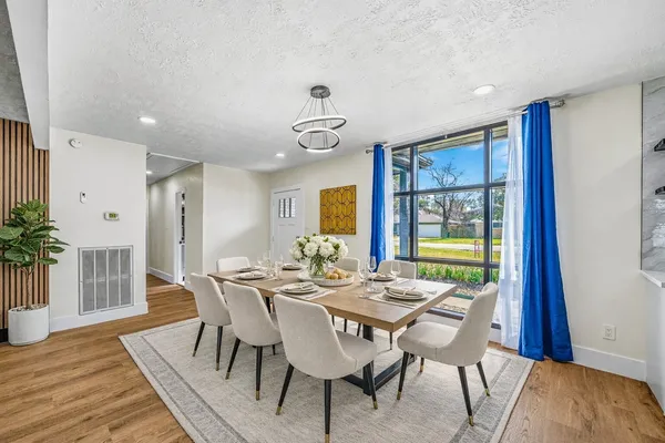a view of a dining room with furniture window and wooden floor