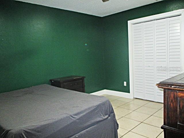 12932 81st Avenue Seminole, FL 33776 - Photo 23 of 27 a bedroom with a bed and a window