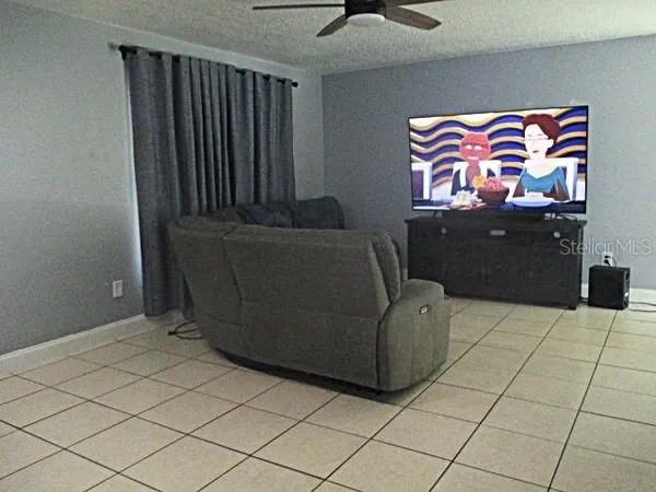 a living room with furniture and wall paintings