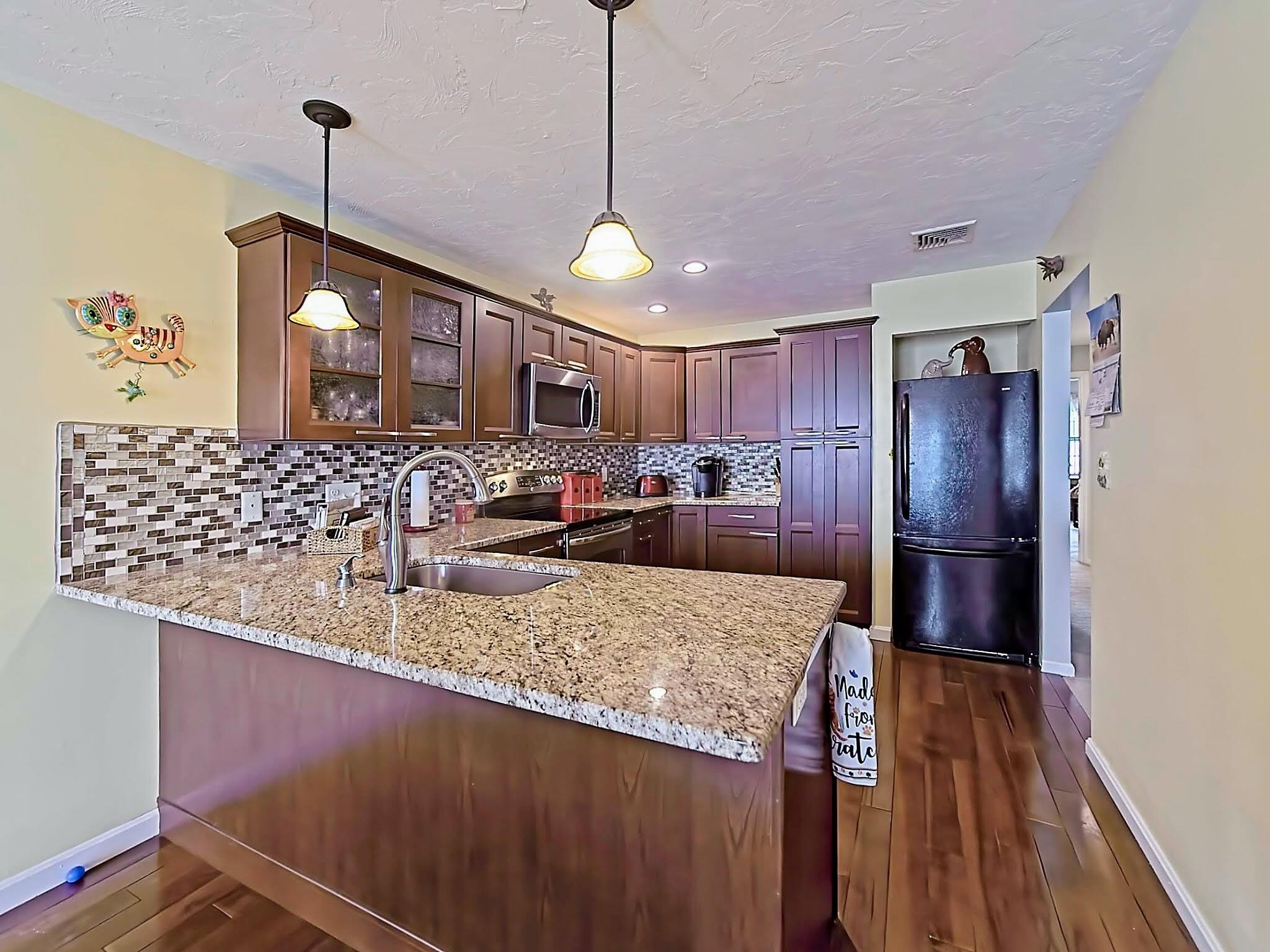 700 Shore Drive, Unit 1205 Fall River, MA 02721 - Photo 12 of 22 a kitchen with stainless steel appliances granite countertop a sink refrigerator and cabinets