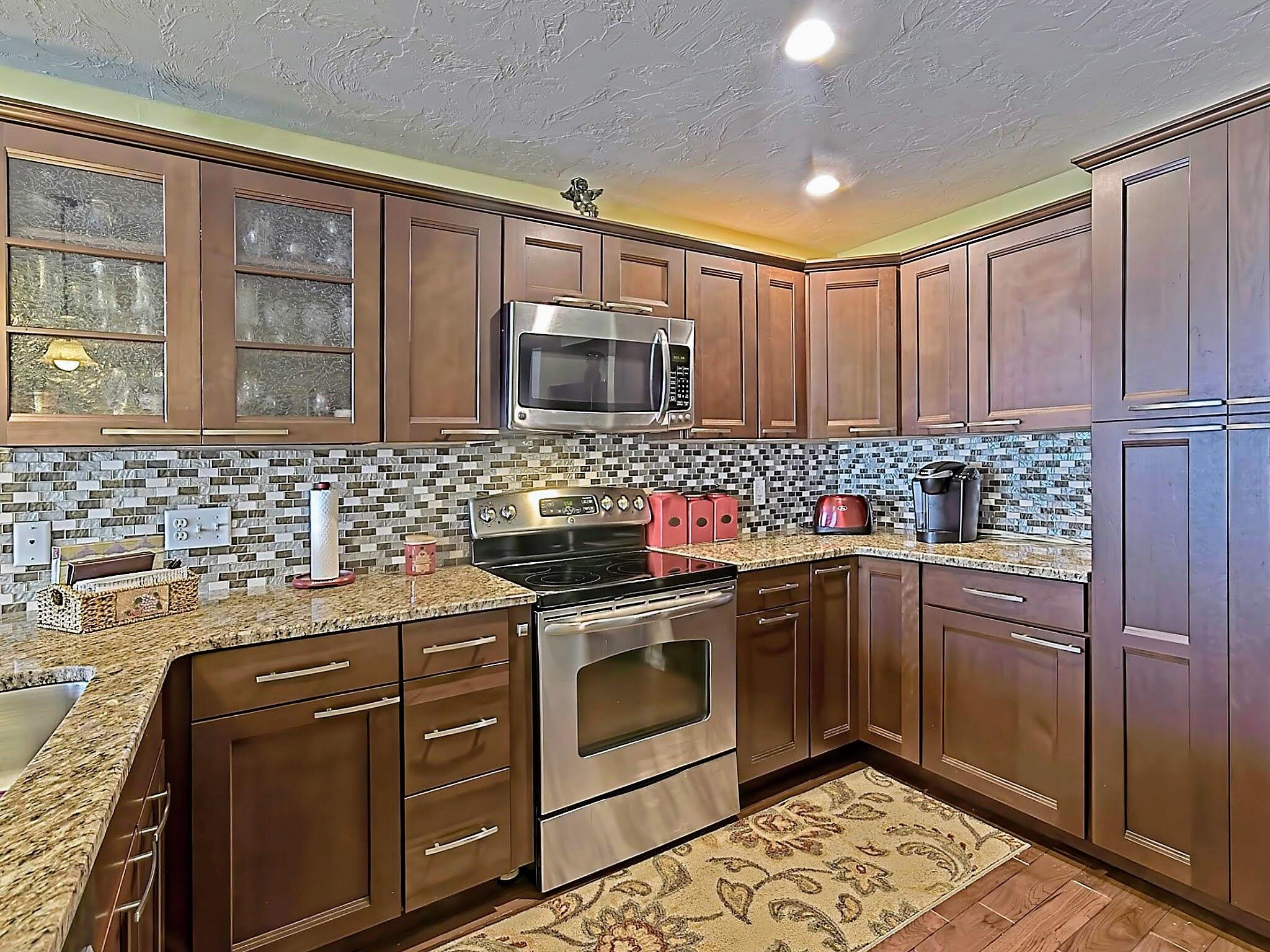 700 Shore Drive, Unit 1205 Fall River, MA 02721 - Photo 13 of 22 a kitchen with stainless steel appliances granite countertop a stove sink and cabinets
