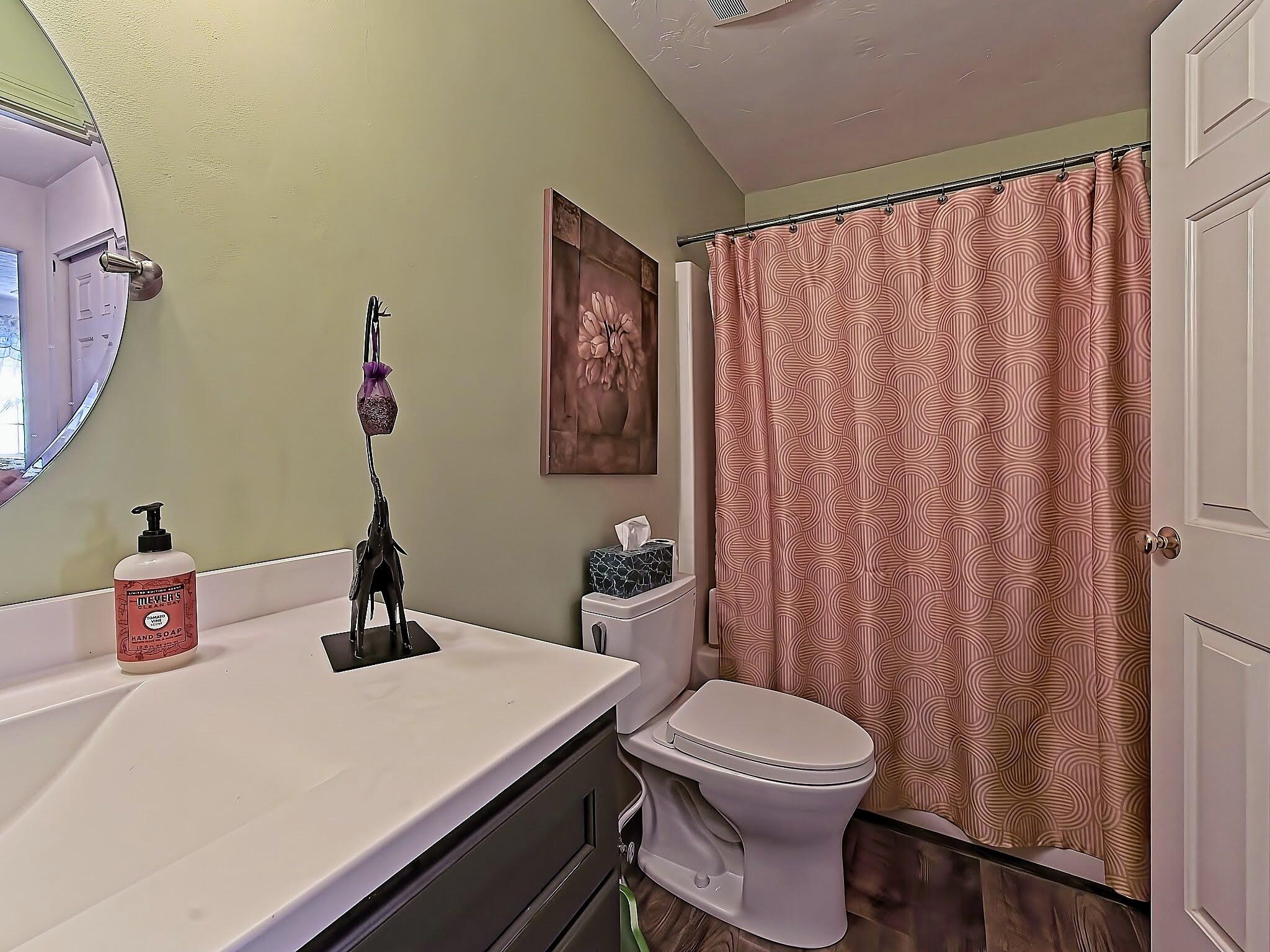 700 Shore Drive, Unit 1205 Fall River, MA 02721 - Photo 17 of 22 a bathroom with a sink a toilet and shower curtain