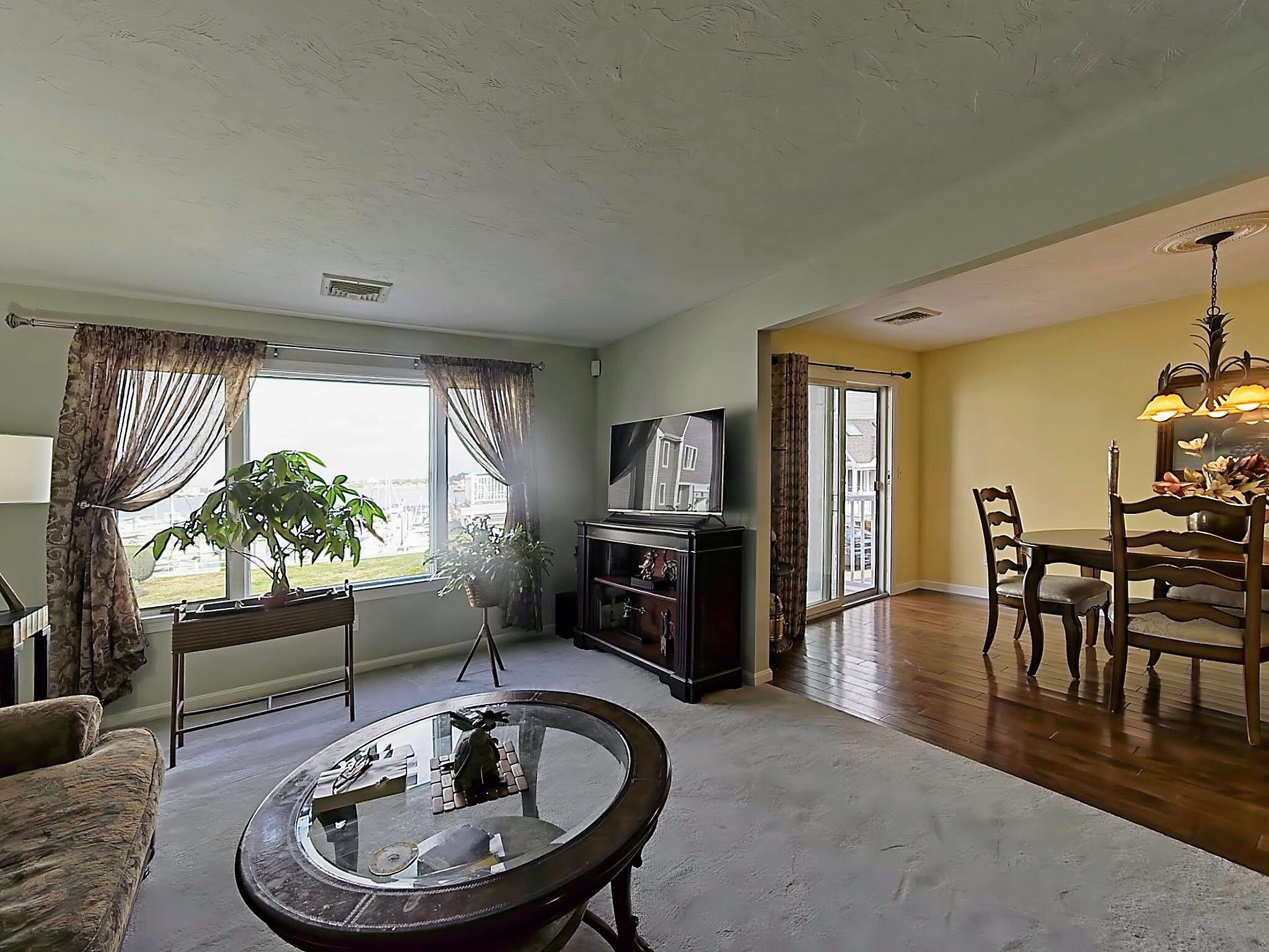 700 Shore Drive, Unit 1205 Fall River, MA 02721 - Photo 5 of 22 a living room with furniture a fireplace and a table