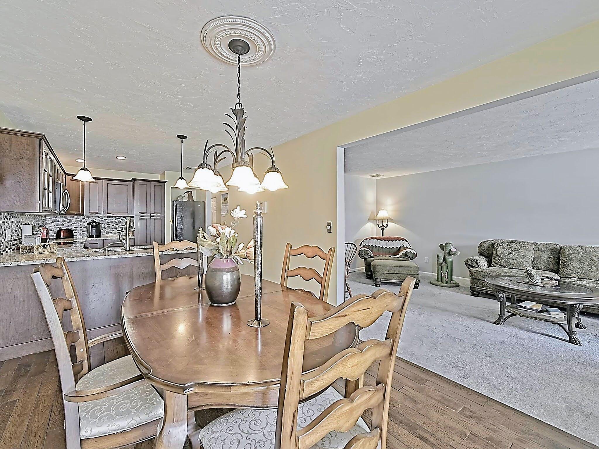 700 Shore Drive, Unit 1205 Fall River, MA 02721 - Photo 9 of 22 a dining room filled chandelier and wooden floor
