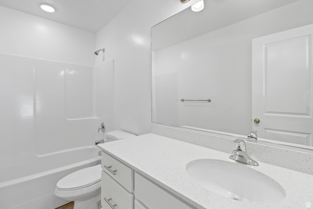 1271 West 500 South Logan, UT 84321 - Photo 23 of 26 Bathroom featuring a white vanity with an integrated sink, polished chrome faucet, and a large mirror