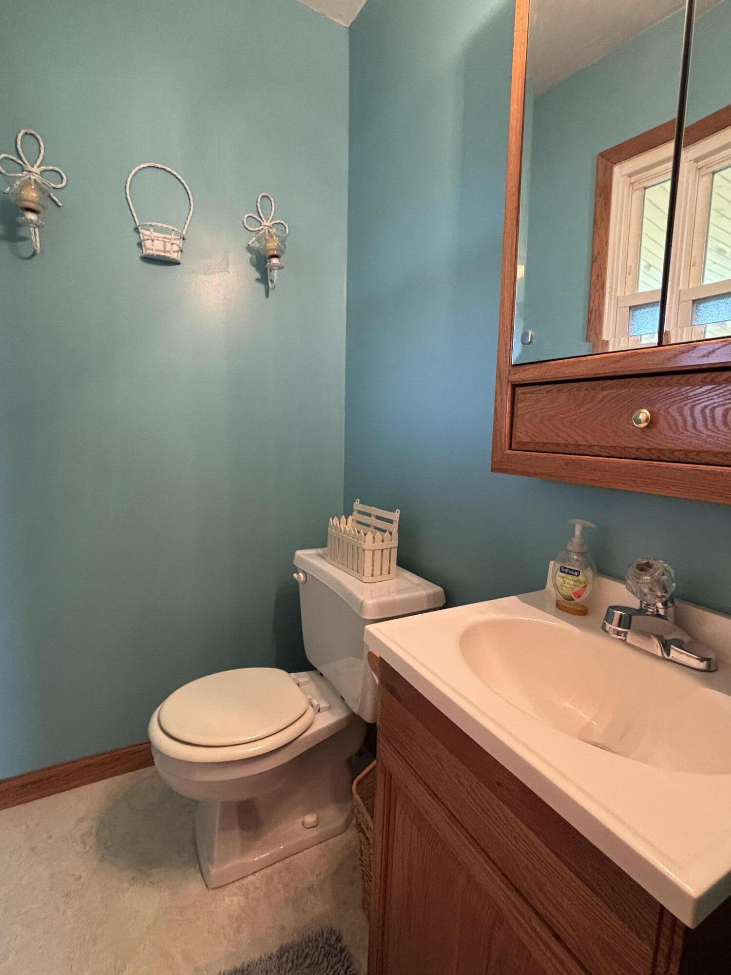 870 Bunkum Road Rensselaer, IN 47978 - Photo 13 of 33 a bathroom with a sink a toilet and mirror