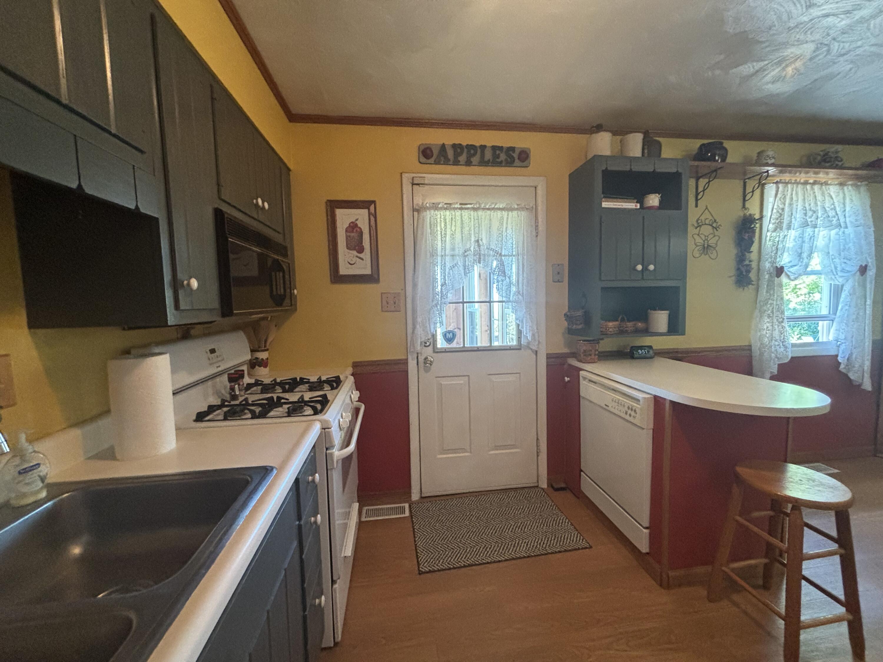 870 Bunkum Road Rensselaer, IN 47978 - Photo 4 of 33 a kitchen with sink a stove and chairs