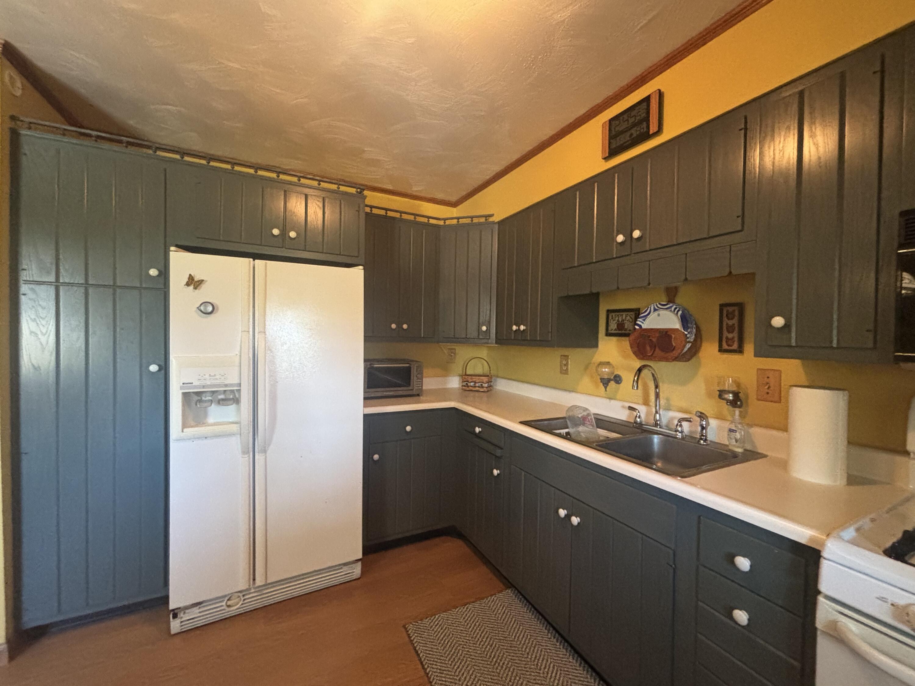 870 Bunkum Road Rensselaer, IN 47978 - Photo 5 of 33 a kitchen with stainless steel appliances granite countertop a refrigerator and a sink