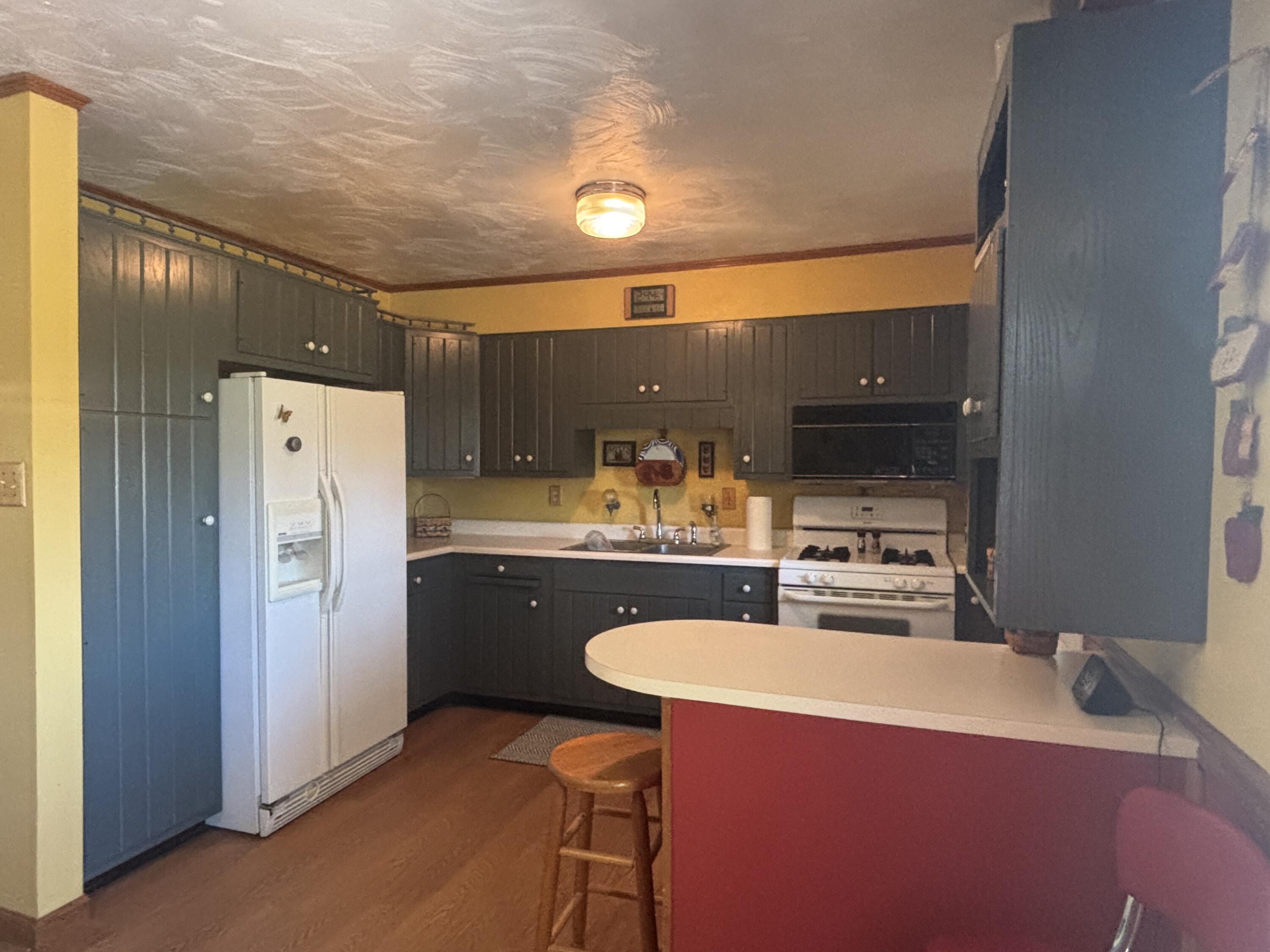 870 Bunkum Road Rensselaer, IN 47978 - Photo 8 of 33 a kitchen with kitchen island a sink stove and refrigerator