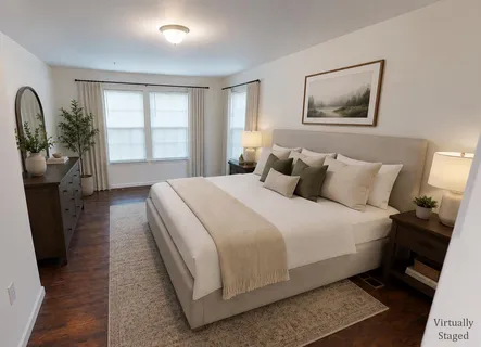 a bedroom with a bed and a potted plant