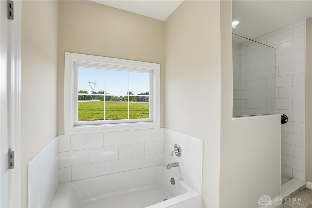 4600 Beal Road Franklin, OH 45005 - Photo 19 of 42 This bright bathroom features a spacious tub and shower, offering a refreshing start to your day.