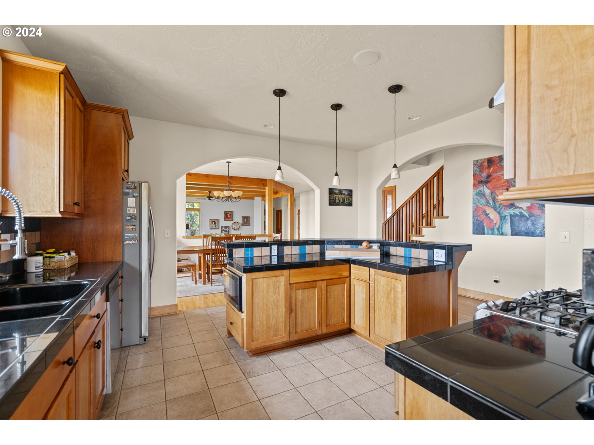 72217 Quill Point Pendleton, OR 97801 - Photo 25 of 48 a kitchen with stainless steel appliances granite countertop a stove and white cabinets