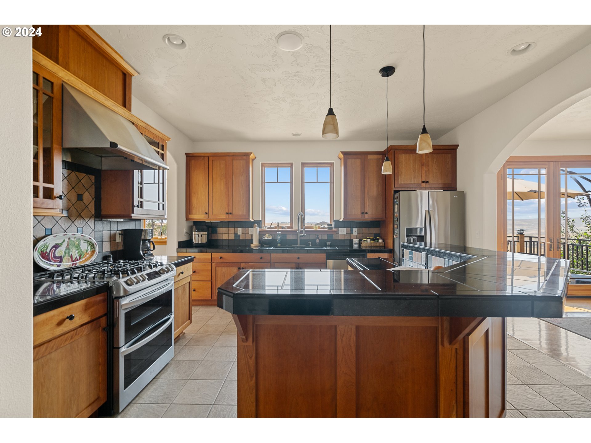 72217 Quill Point Pendleton, OR 97801 - Photo 28 of 48 a kitchen with stainless steel appliances granite countertop a sink a stove and a refrigerator