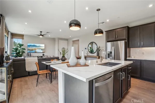 a kitchen with a table chairs stove and refrigerator