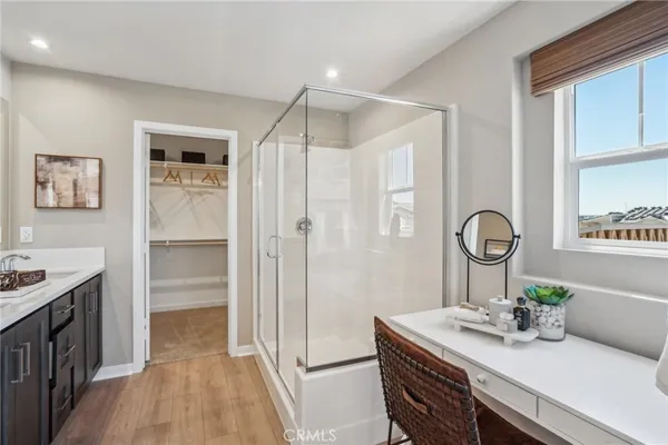 a room with a table chairs and a refrigerator