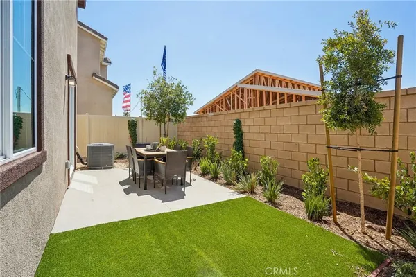 a view of a patio with table and chairs and potted plants