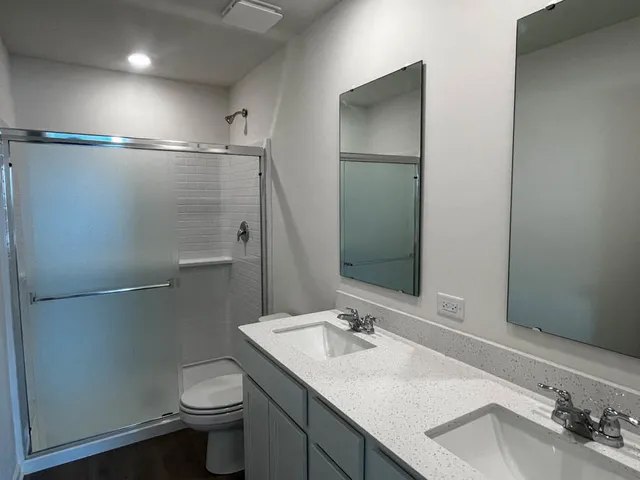 a bathroom with a sink toilet and shower