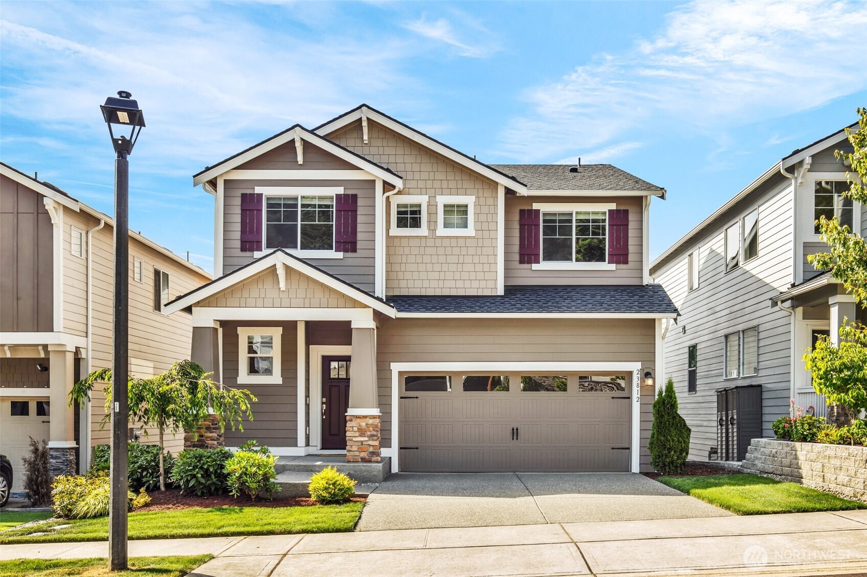 23812 Southeast 291st Street Maple Valley, WA 98010 - Photo 1 of 40 a front view of a house with a yard