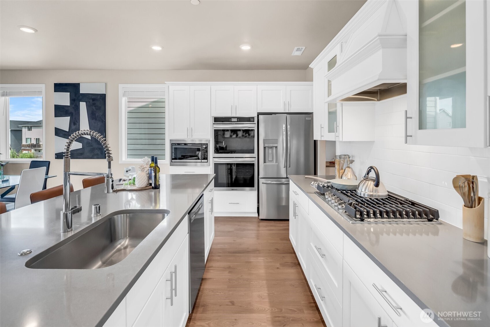 23812 Southeast 291st Street Maple Valley, WA 98010 - Photo 11 of 40 a kitchen with stainless steel appliances granite countertop a sink and stove