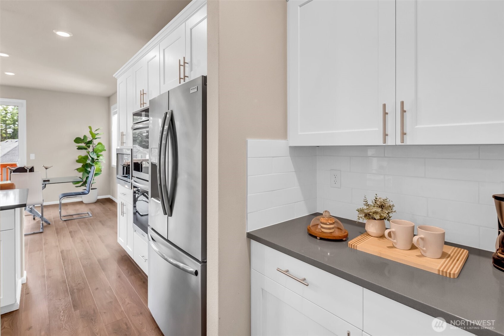 23812 Southeast 291st Street Maple Valley, WA 98010 - Photo 18 of 40 a kitchen with stainless steel appliances a refrigerator a sink and cabinets