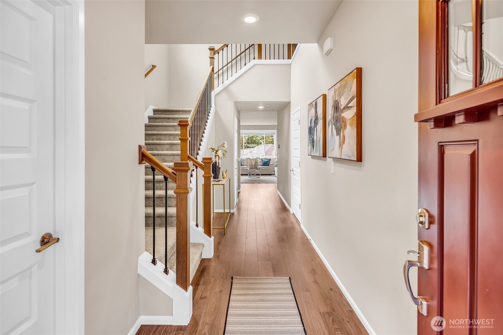 23812 Southeast 291st Street Maple Valley, WA 98010 - Photo 4 of 40 a view of a hallway with wooden floor and staircase