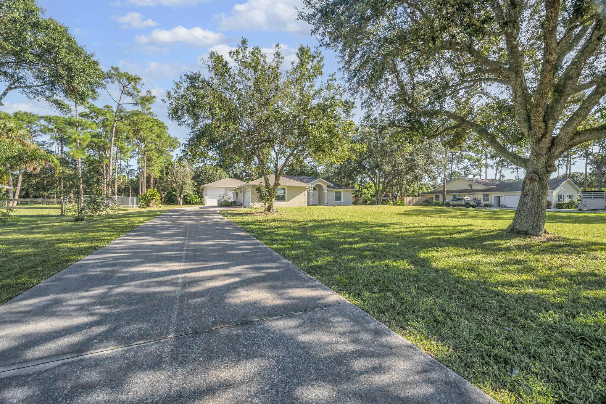 8330 Hidden Pines Road Fort Pierce, FL 34945 - Photo 1 of 34 a view of a park with large trees