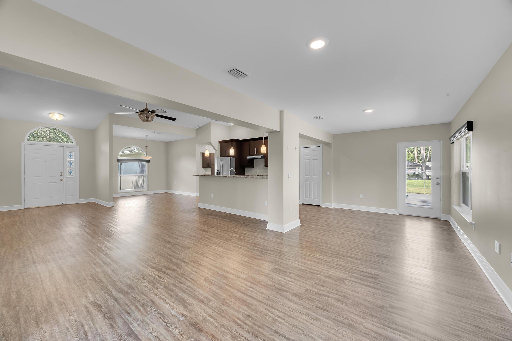 8330 Hidden Pines Road Fort Pierce, FL 34945 - Photo 19 of 34 a view of an empty room with window and wooden floor