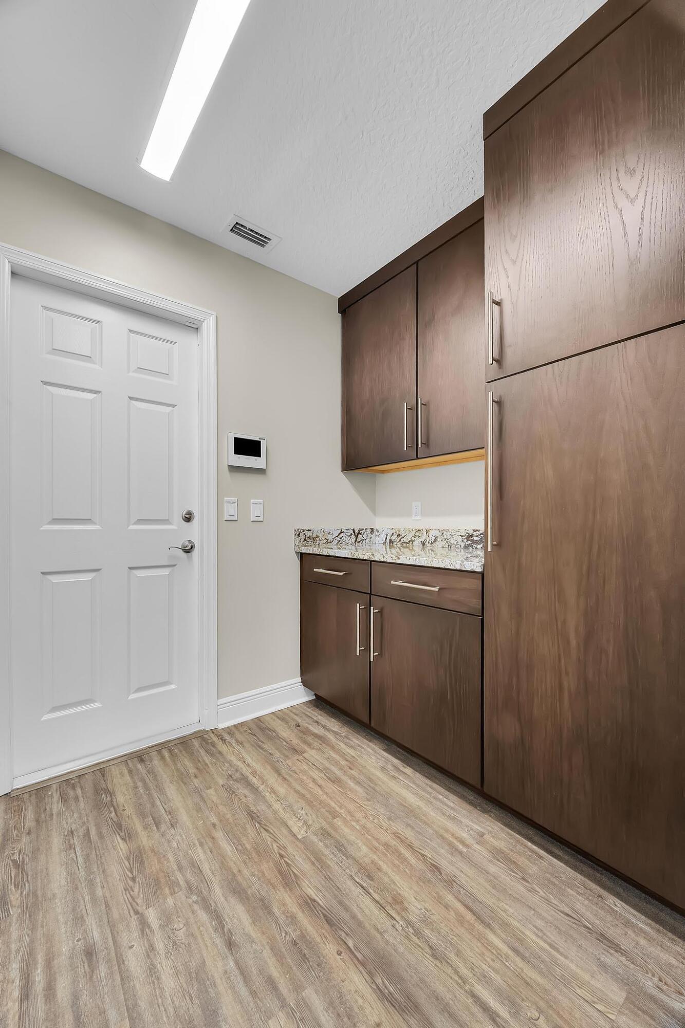 8330 Hidden Pines Road Fort Pierce, FL 34945 - Photo 22 of 34 a kitchen with a refrigerator sink and cabinets
