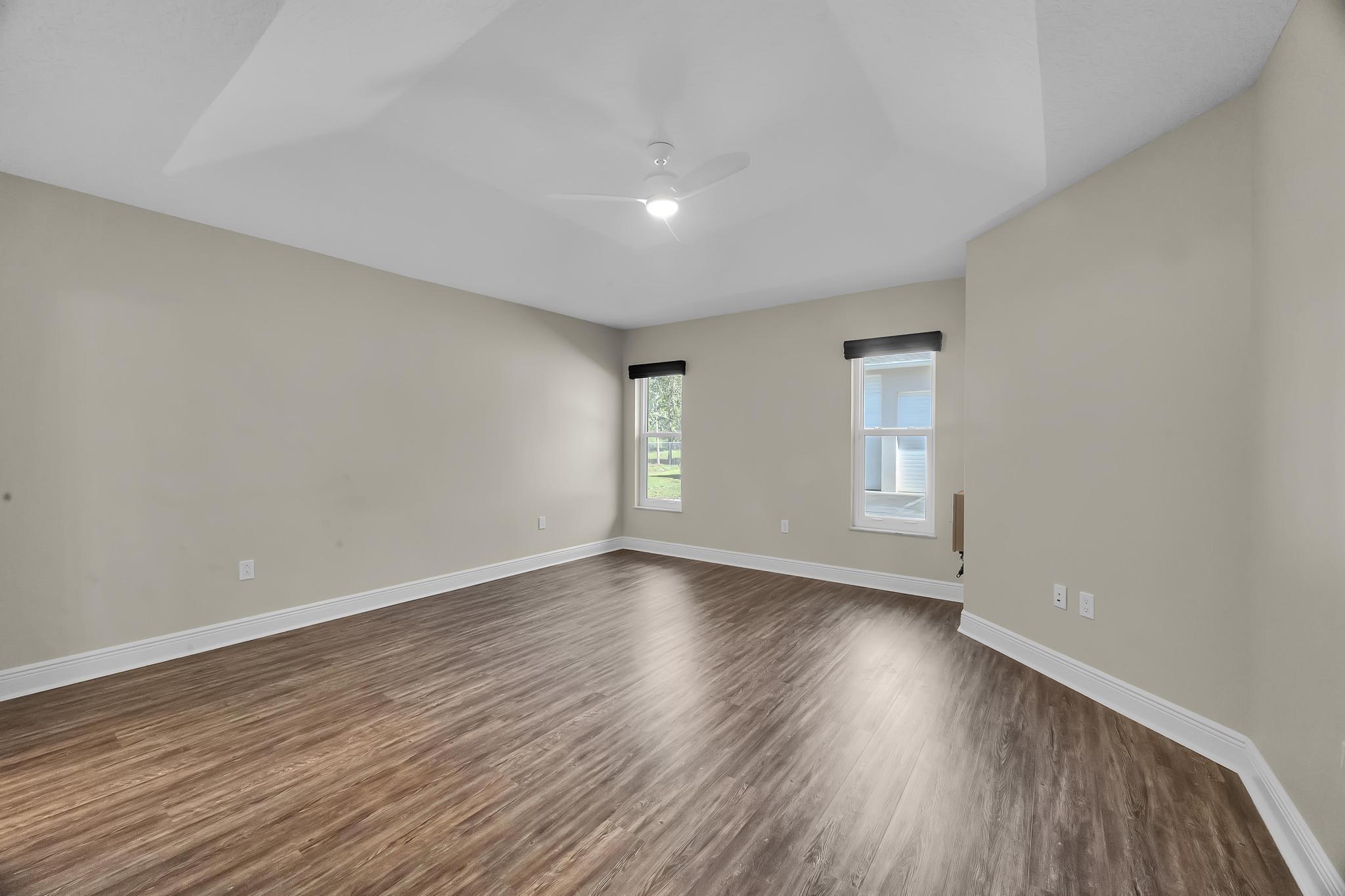 8330 Hidden Pines Road Fort Pierce, FL 34945 - Photo 23 of 34 a view of an empty room with wooden floor and window
