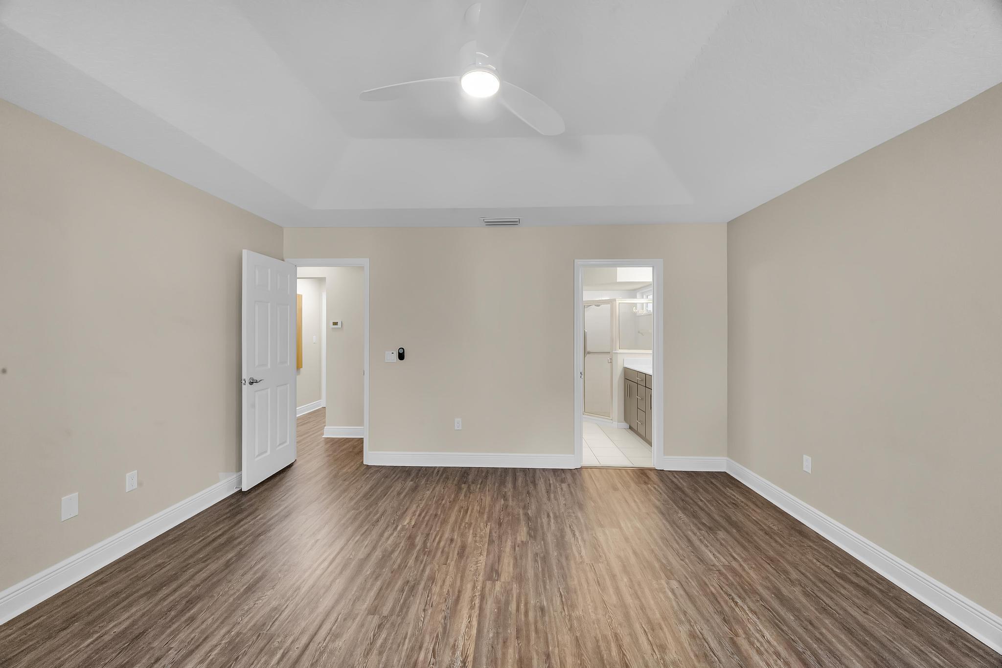 8330 Hidden Pines Road Fort Pierce, FL 34945 - Photo 24 of 34 wooden floor in an empty room with a window