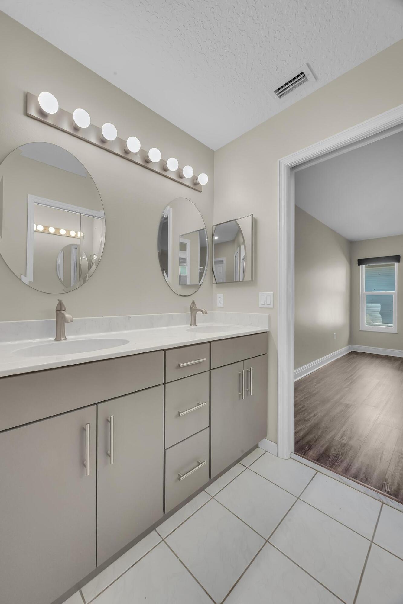 8330 Hidden Pines Road Fort Pierce, FL 34945 - Photo 25 of 34 a spacious bathroom with double sink and a mirror