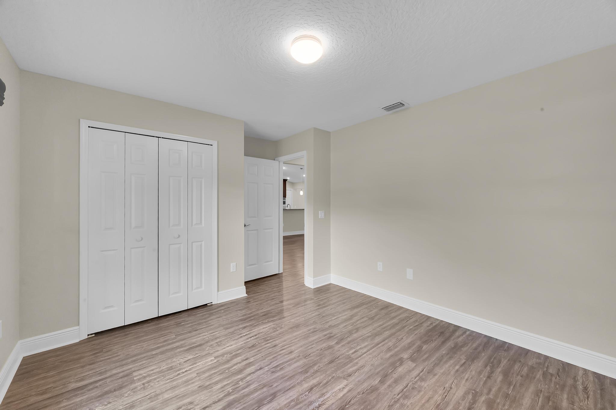 8330 Hidden Pines Road Fort Pierce, FL 34945 - Photo 28 of 34 a view of empty room with wooden floor