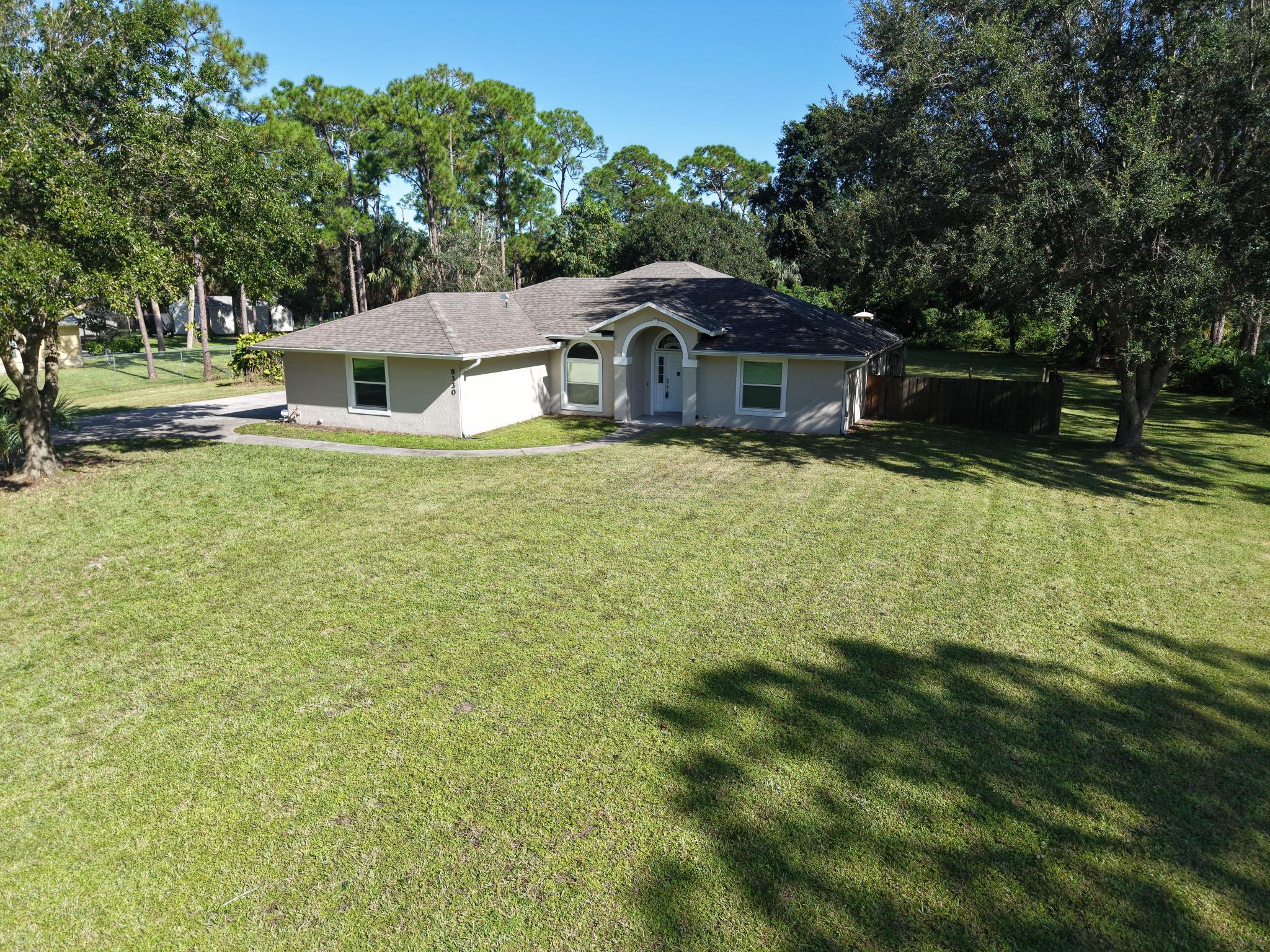 8330 Hidden Pines Road Fort Pierce, FL 34945 - Photo 7 of 34 a front view of a house with a yard