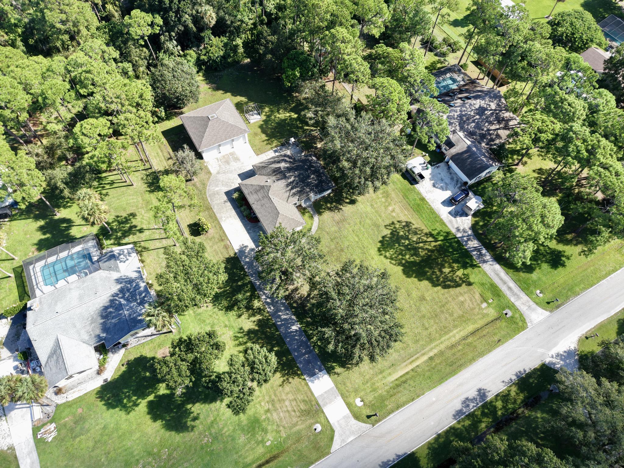 8330 Hidden Pines Road Fort Pierce, FL 34945 - Photo 9 of 34 an aerial view of house with yard