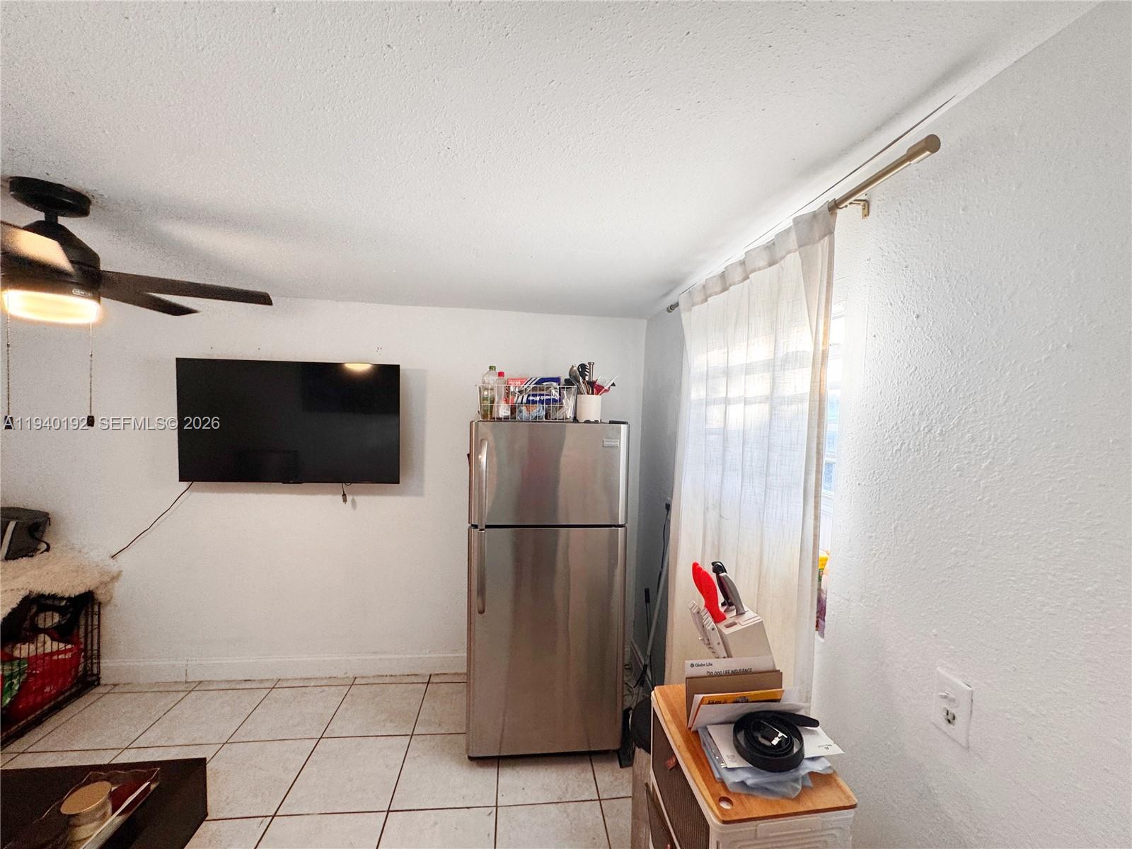 195 Northwest 135th Street Miami, FL 33168 - Photo 3 of 7 a living room with a couch and a flat screen tv