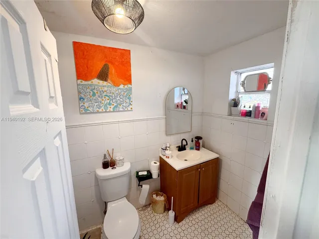 a bathroom with a sink mirror and toilet