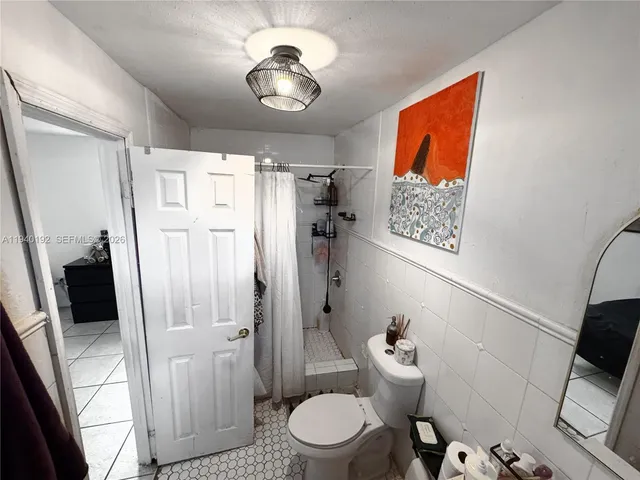 a bathroom with a toilet sink and shower