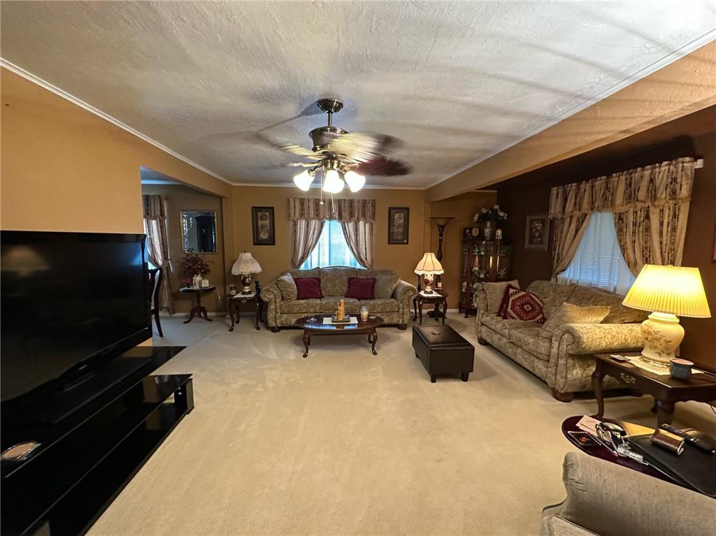 696 Leighty Hollow Road Ruffs Dale, PA 15679 - Photo 13 of 46 a living room with furniture and a flat screen tv