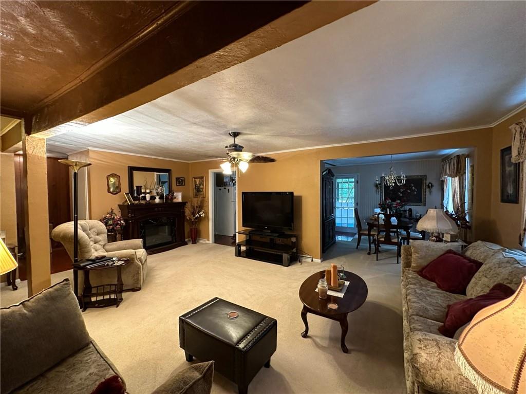 696 Leighty Hollow Road Ruffs Dale, PA 15679 - Photo 15 of 46 a living room with furniture a flat screen tv and a fireplace
