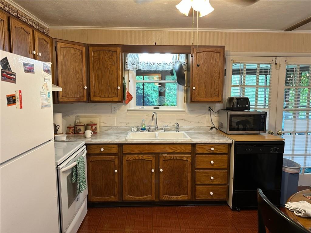696 Leighty Hollow Road Ruffs Dale, PA 15679 - Photo 16 of 46 a kitchen with a sink a stove a refrigerator and a window